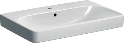 A white ceramic sink with a faucet hole and overflow drain, shown from a slightly elevated angle against a white background.