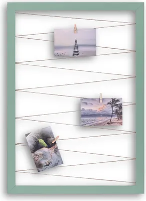 A photo frame with strings and clothespins holding photos.