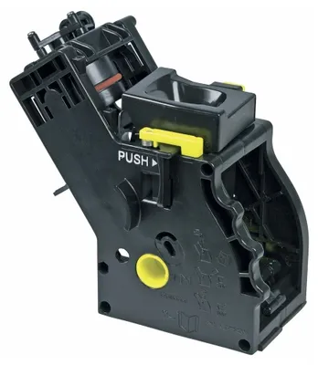 A black plastic coffee machine brewing unit with yellow accents and some text.