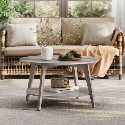 A living room scene with a coffee table in the foreground and a sofa in the background.