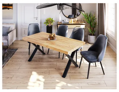 A dining room scene with a wooden table and chairs, a console table, and a sofa in the background.
