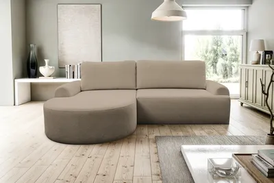 A modern living room with a sectional sofa, coffee table, and a cabinet.