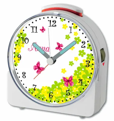 A close-up view of a white alarm clock with a butterfly and floral design.