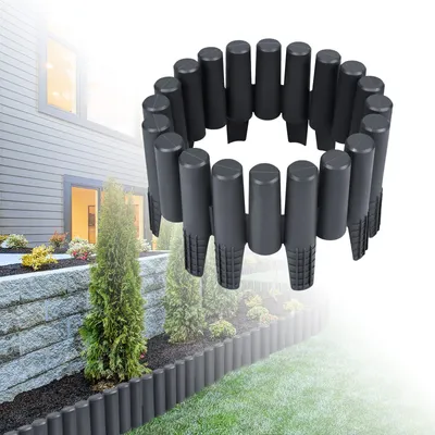 A garden border made of plastic stakes is shown in a circular arrangement, with a blurred background of a house and garden.