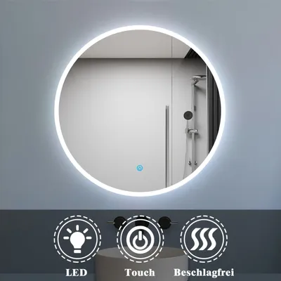 A round illuminated mirror is shown on a light gray wall, with icons and text below indicating features. The mirror reflects a shower area.