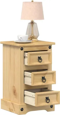 A wooden nightstand with three drawers, a cup and saucer on top, and a lamp.