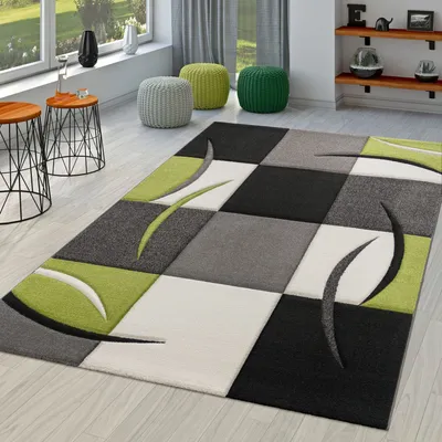 A modern living room with a geometric rug, side tables, and poufs.