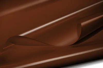 A close-up, abstract shot of a brown, glossy material, likely a tarp or fabric, with soft lighting and smooth curves.