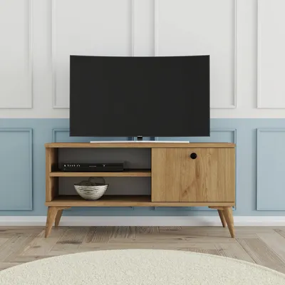 A TV stand with a TV on top, in a room with blue and white paneled walls.