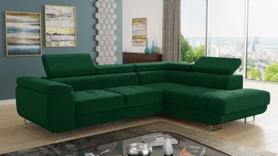 A green sectional sofa is shown in a well-lit room with a large window overlooking a city.