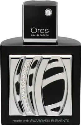 A studio shot of a black and silver perfume bottle with crystal accents.