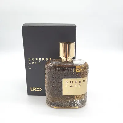 A bottle of Superbe Café Eau de Parfum and its packaging are displayed against a white background.