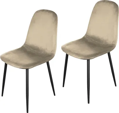 Two beige velvet dining chairs with black legs, shown from a three-quarter angle against a white background.
