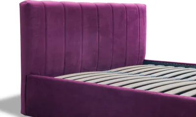Close-up of a purple upholstered bed frame with a slatted base.