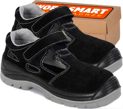 A pair of black work boots with a cardboard box in the background.