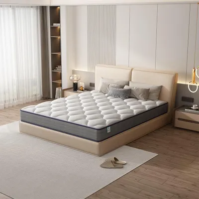 A mattress is displayed on a bed frame in a bedroom setting.