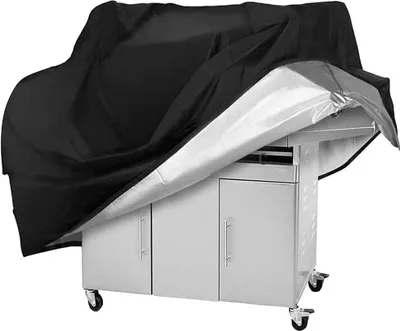 A black grill cover is partially covering a stainless steel grill cart.