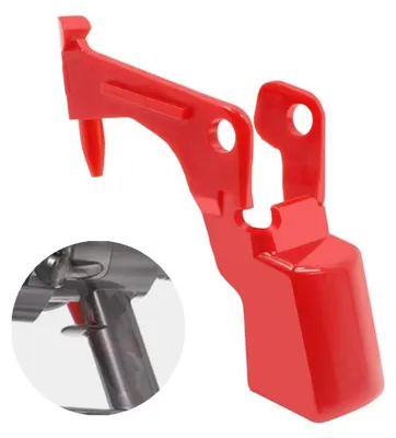 A red plastic object, likely a part for machinery or an appliance.