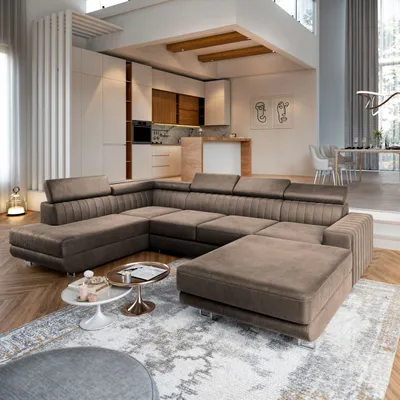 A modern living room with a large sectional sofa in the foreground and a kitchen and dining area in the background.