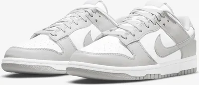 A pair of Nike Dunk Low Retro sneakers in white and grey fog.