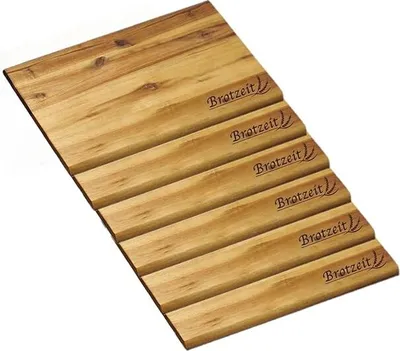 A wooden cutting board with grooves and the brand name "Brotzeit" imprinted on it.