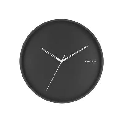 A black Karlsson wall clock with white hands is shown against a white background.