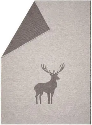 A folded blanket with a deer silhouette pattern.