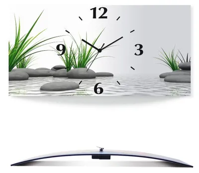 A wall clock with a zen-like design featuring stones and grass in water.