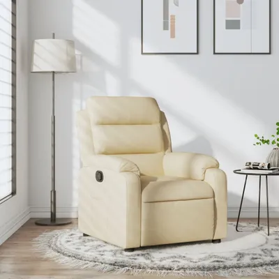 A cream-colored recliner chair is shown in a well-lit room with a floor lamp and artwork on the wall.