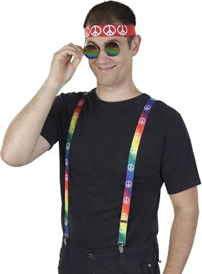 A man wearing a hippie costume with a peace sign headband and rainbow suspenders.