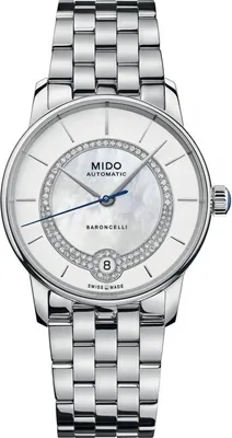A close-up studio shot of a silver Mido watch with a white dial and diamond accents.