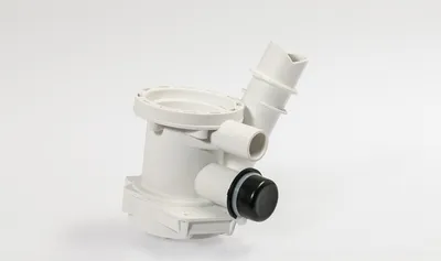 A white washing machine part, likely a filter housing, is shown against a plain white background.