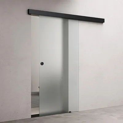 A frosted glass sliding door with a black handle and track, mounted on a light gray wall.