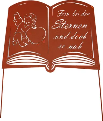 A metal garden stake shaped like an open book with an angel and text.