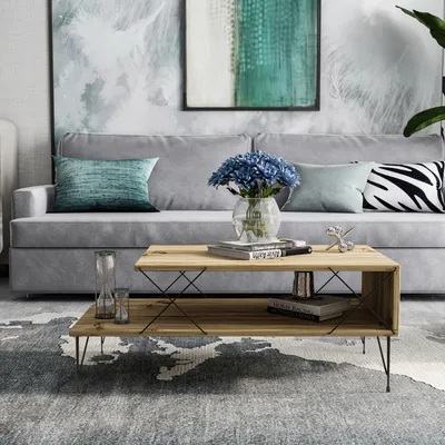 A living room scene with a couch, coffee table, and artwork.