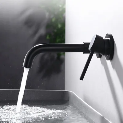 A black wall-mounted faucet is shown dispensing water into a sink.