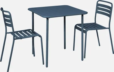 A blue metal table and two chairs set against a white background.