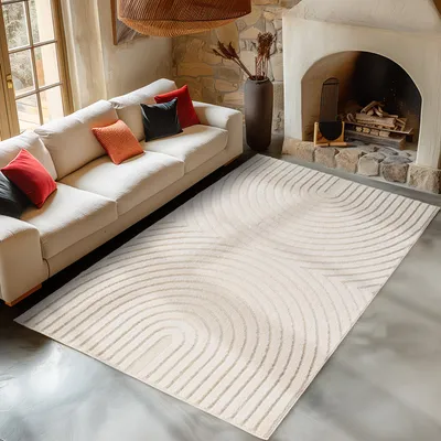 A living room scene with a sofa, fireplace, and a rug.