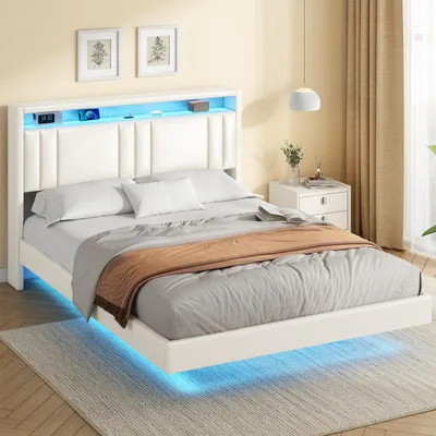 A bedroom scene with a white bed featuring LED lighting.