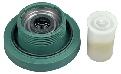 A green washing machine part and a small container of lubricant are shown against a white background.