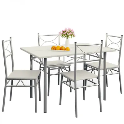 A dining set with a table and four chairs, with a vase of flowers and fruit on the table.
