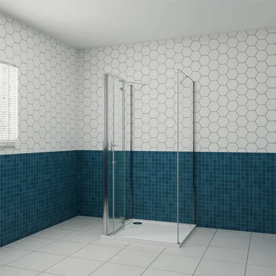 A modern bathroom with a glass shower enclosure against a tiled wall.