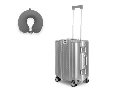 A silver suitcase and a gray neck pillow are displayed against a white background.