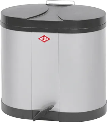 A silver pedal bin with a black lid and a red Wesco logo.