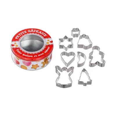 A tin of cookie cutters and several cookie cutters arranged next to it.