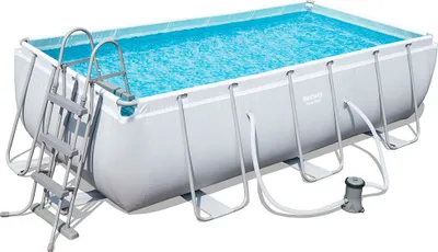 A rectangular above-ground swimming pool filled with blue water, with a ladder and a pump visible.