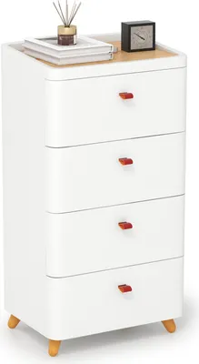 A white four-drawer nightstand with red drawer pulls and wooden legs, placed on a white background. The top of the nightstand has a wooden surface with a stack of books, a small vase with reeds, and a black alarm clock.