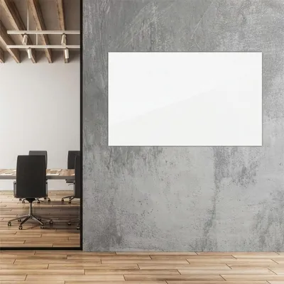 A modern office or meeting room with a whiteboard on a concrete wall.