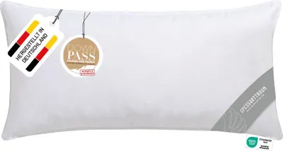 A white pillow with tags attached.