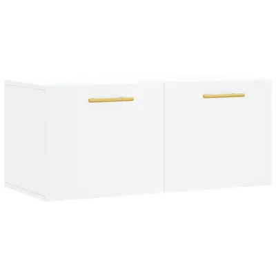 A white wall-mounted cabinet with two doors and gold handles, shown against a white background.